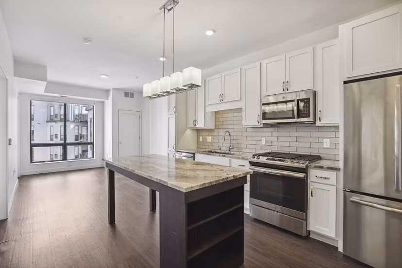 Modern kitchen with sleek countertops and stainless steel appliances at Avidor Edina Apartments