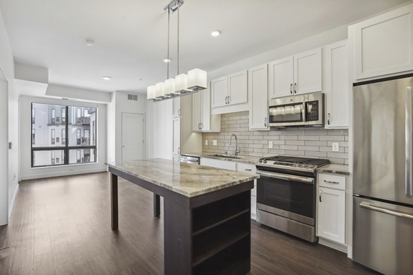 Modern kitchen with sleek countertops and stainless steel appliances at Avidor Edina Apartments