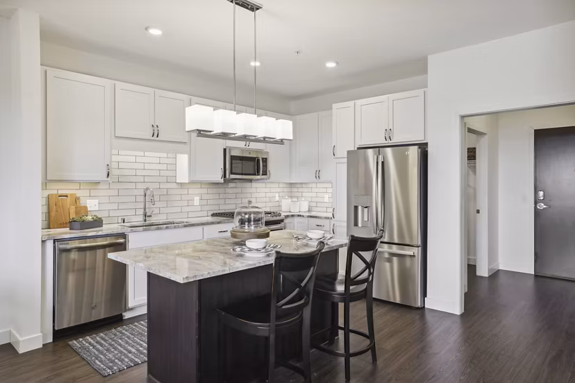 Modern kitchen with sleek cabinetry and stainless steel appliances at Avidor Edina Apartments