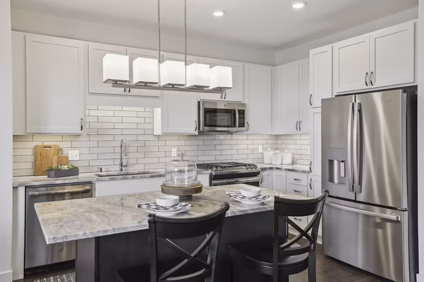 Avidor Edina: Modern kitchen with sleek countertops and stainless appliances in luxury apartments