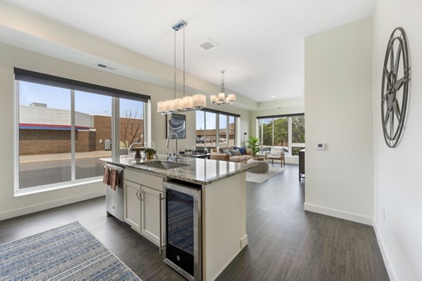 Modern kitchen featuring stainless steel appliances and granite countertops at Avidor Minnetonka Apartments