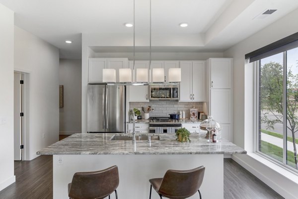 Contemporary kitchen with stainless steel appliances at Avidor Minnetonka Apartments