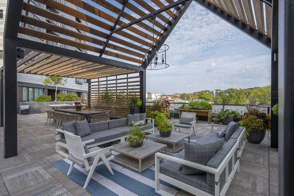 Rooftop deck with seating and greenery at Avidor Minnetonka Apartments, offering stunning views and leisure space for residents