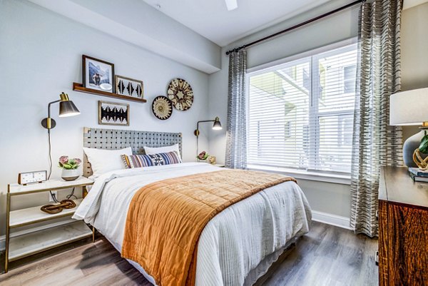 Spacious bedroom with modern furnishings at Zoey Apartments