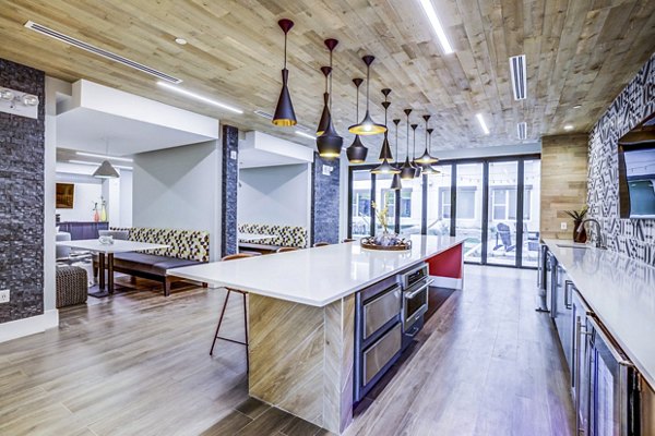 Clubhouse kitchen with modern appliances at Zoey Apartments, a Greystar luxury community