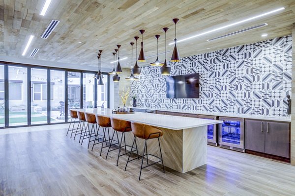 Clubhouse kitchen featuring modern appliances and spacious seating at Zoey Apartments Ideal for socializing and hosting events