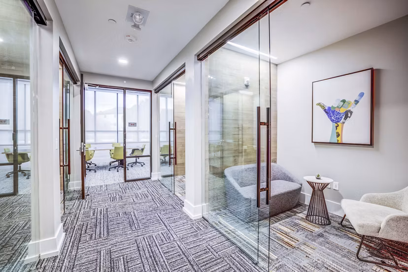 Clubhouse meeting facility featuring modern seating and large conference table at Zoey Apartments, ideal for gatherings and events