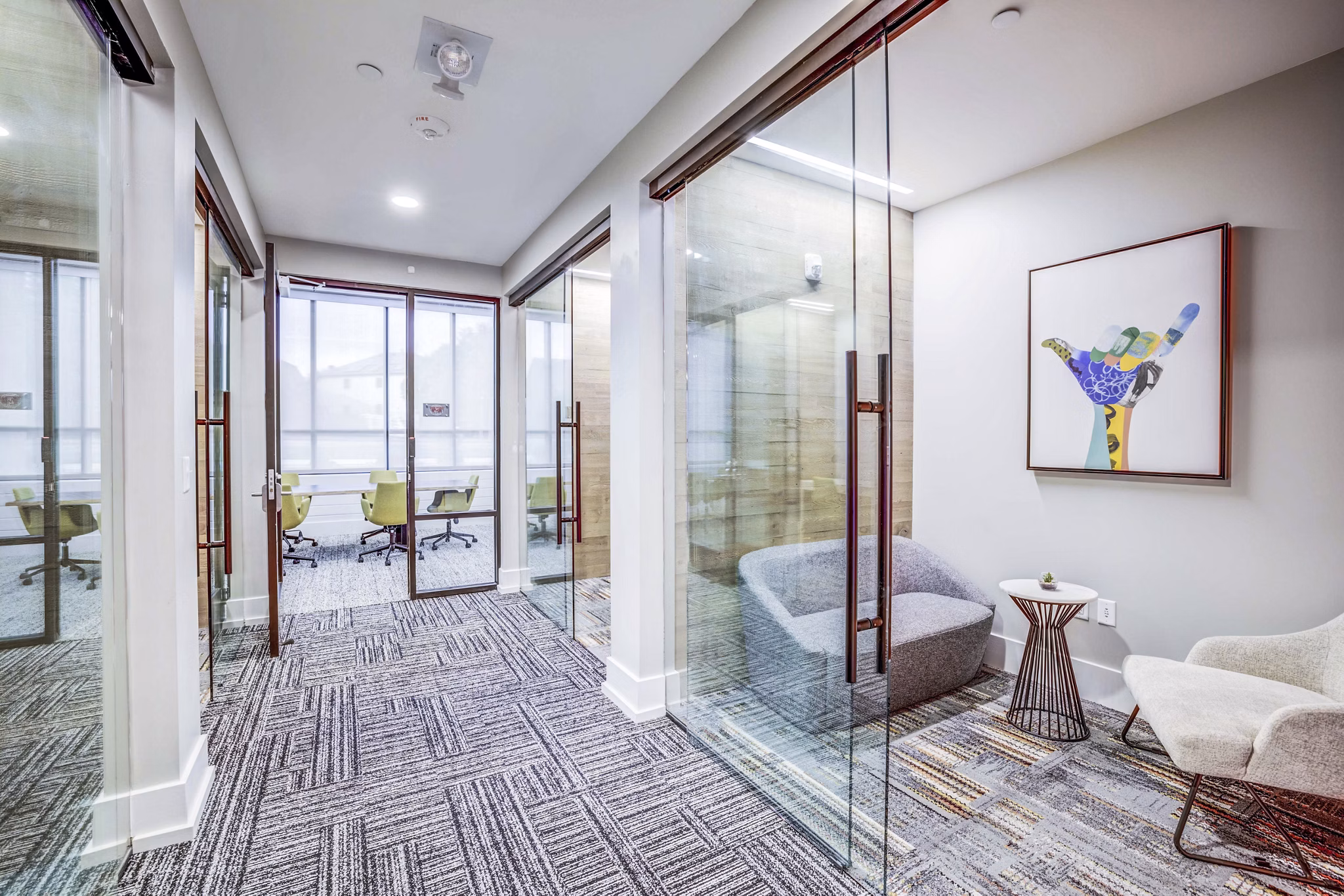Clubhouse meeting facility featuring modern seating and large conference table at Zoey Apartments, ideal for gatherings and events