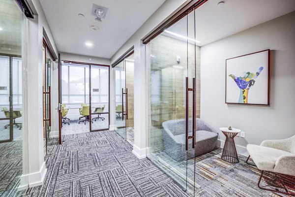 Clubhouse meeting facility featuring modern seating and large conference table at Zoey Apartments, ideal for gatherings and events