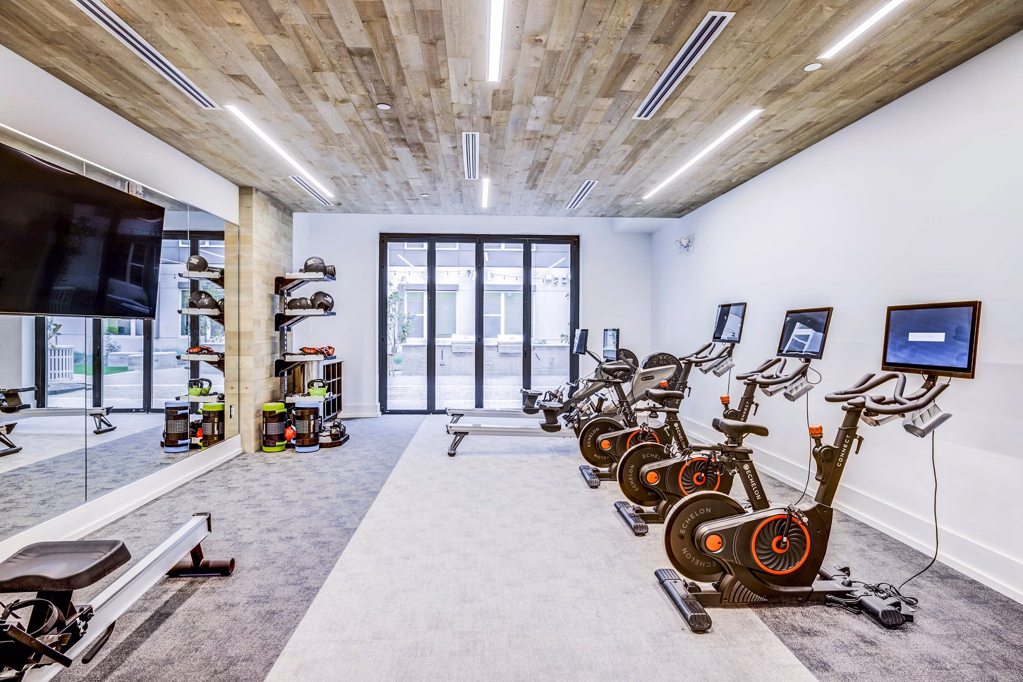 Spin studio featuring state-of-the-art bikes and yoga space at Zoey Apartments Ideal for fitness enthusiasts seeking luxury at Greystar properties