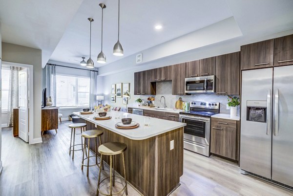 Luxury kitchen featuring stainless steel appliances and granite countertops at Zoey Apartments in vibrant neighborhood