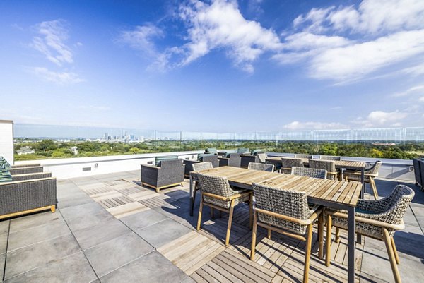 Cozy patio with modern seating at Zoey Apartments, ideal for relaxation and enjoying outdoor views