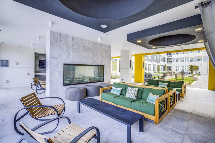 Cozy outdoor fire pit and seating area on the patio at Zoey Apartments