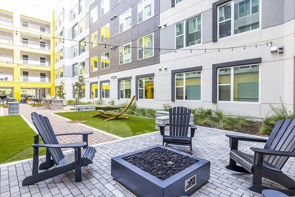 Cozy outdoor fire pit area at Zoey Apartments, perfect for social gatherings and relaxation