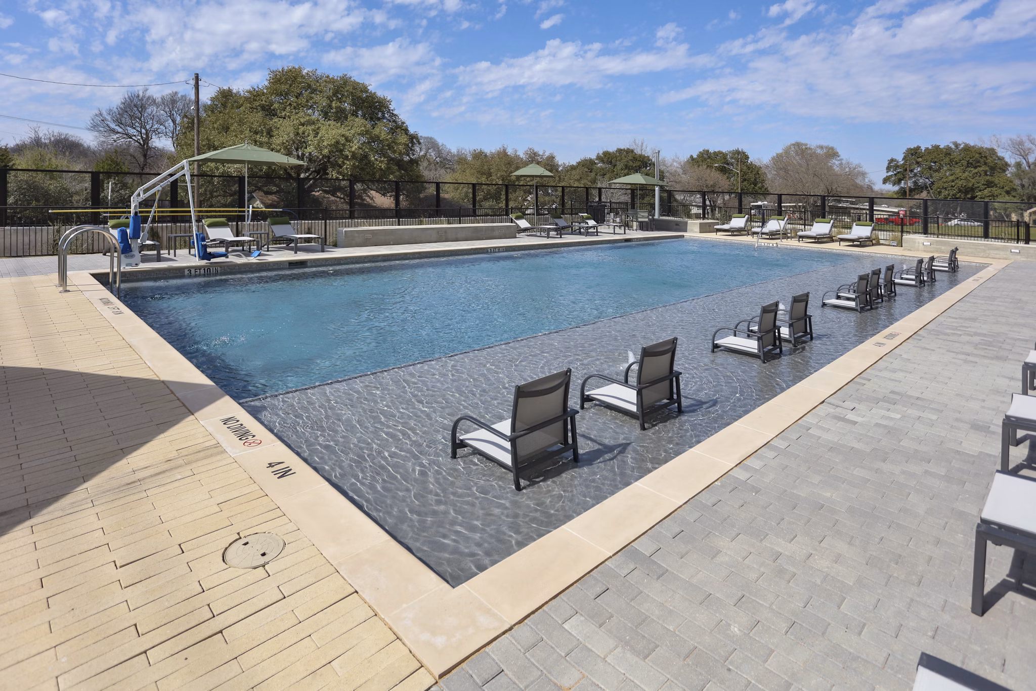 Resort-style pool with sun loungers at Zoey Apartments