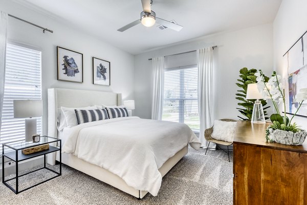 Cozy bedroom with contemporary decor at Tacara Dove Creek Apartments, offering luxury living in a serene environment