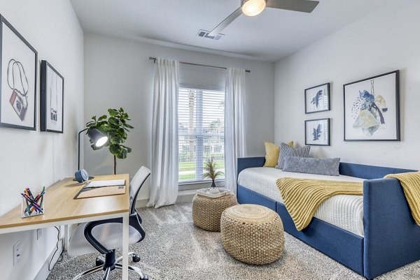 Cozy bedroom with home office setup in Tacara Dove Creek Apartments