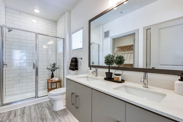Luxurious bathroom with marble countertops and modern fixtures at Tacara Dove Creek Apartments