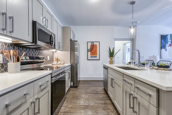 Modern kitchen with stainless steel appliances at Tacara Dove Creek Apartments