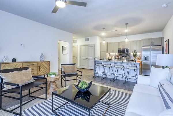 Modern living room with stylish decor and natural light at Tacara Dove Creek Apartments in San Antonio, offering luxurious comfort