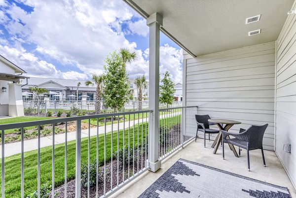 Charming balcony with modern furnishings at Tacara Dove Creek Apartments, ideal for tranquil outdoor relaxation Enjoy the serenity and stylish ambiance