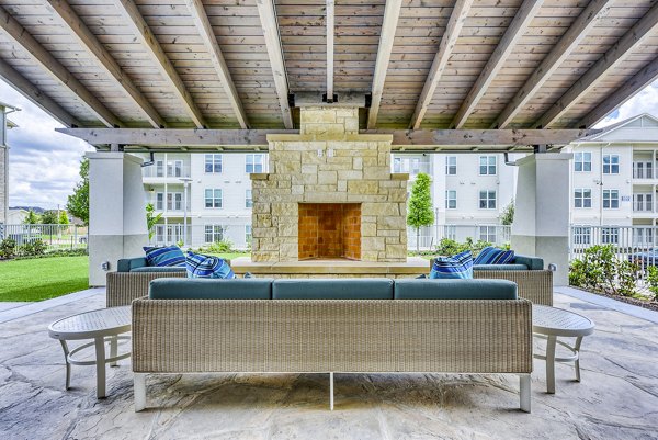 Outdoor fire pit and cozy seating area at Tacara Dove Creek Apartments