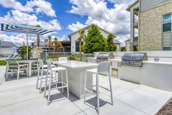 Grill area with modern seating at Tacara Dove Creek Apartments' patio