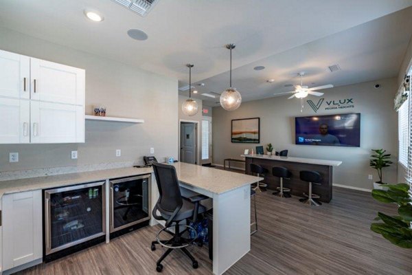 Home office with modern desk and ergonomic chair in Vlux at Sunset Farms Apartments