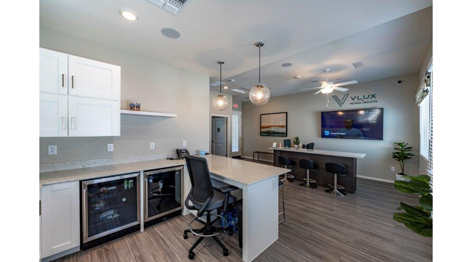 Home office with modern desk and ergonomic chair in Vlux at Sunset Farms Apartments