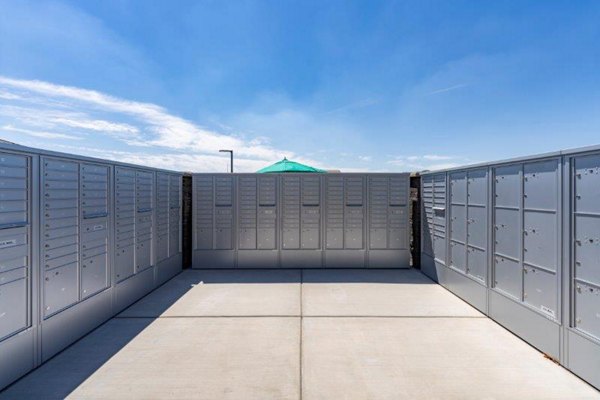 Mail room with secure parcel lockers at Vlux at Sunset Farms Apartments