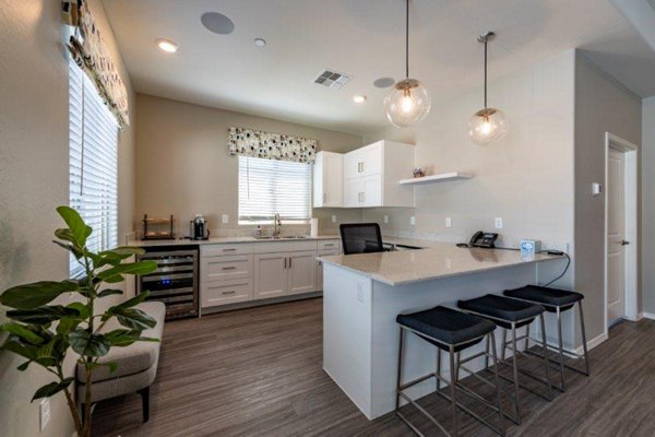 Home office with stylish desk and ergonomic chair at Vlux at Sunset Farms Apartments