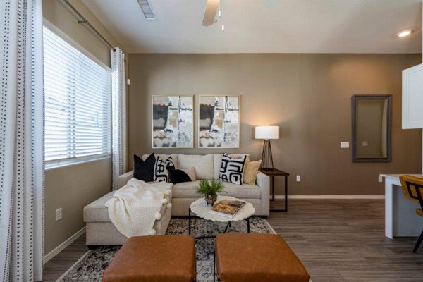 Modern living room with stylish furnishings at Vlux at Sunset Farms Apartments, offering luxury and comfort in a prime location