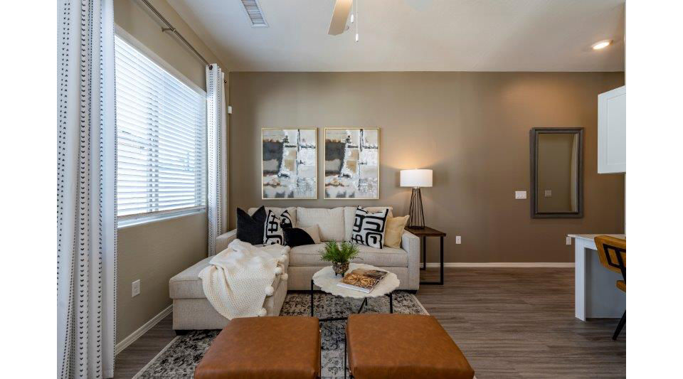 Modern living room with stylish furnishings at Vlux at Sunset Farms Apartments, offering luxury and comfort in a prime location