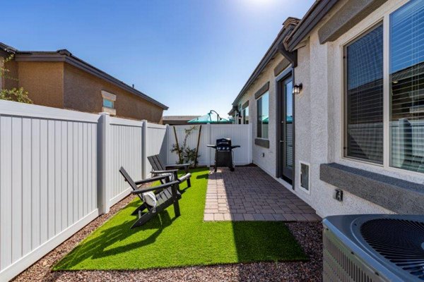 Spacious patio with modern seating at Vlux at Sunset Farms Apartments