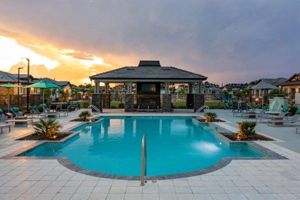 Vlux at Sunset Farms Apartments: Luxury pool with stylish loungers at Greystar community