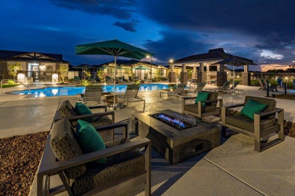 Cozy outdoor fire pit area at Vlux at Sunset Farms Apartments