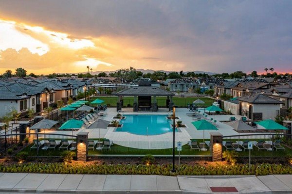 Scenic courtyard view at Vlux at Sunset Farms Apartments, featuring lush greenery and cozy seating areas