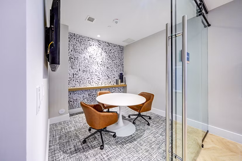Elegant clubhouse meeting facility at The Ellsworth Apartments, featuring modern design and ample seating for residents and guests