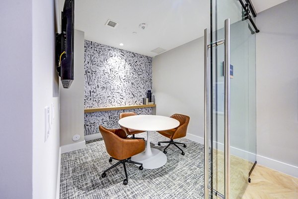 Elegant clubhouse meeting facility at The Ellsworth Apartments, featuring modern design and ample seating for residents and guests