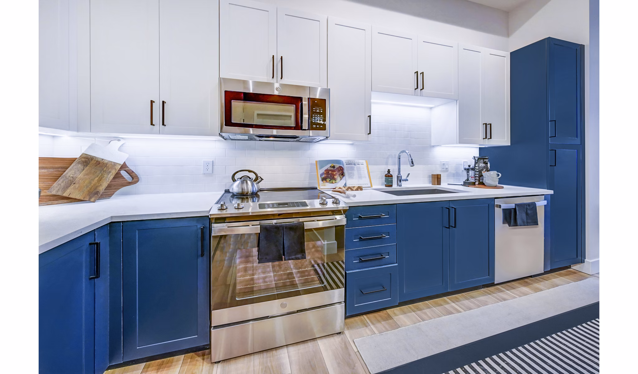 Modern kitchen with stainless steel appliances at The Ellsworth Apartments