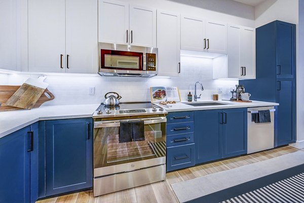 Modern kitchen with stainless steel appliances at The Ellsworth Apartments