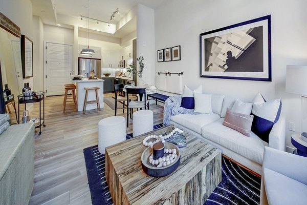 Living room with modern furniture and open layout at The Ellsworth Apartments