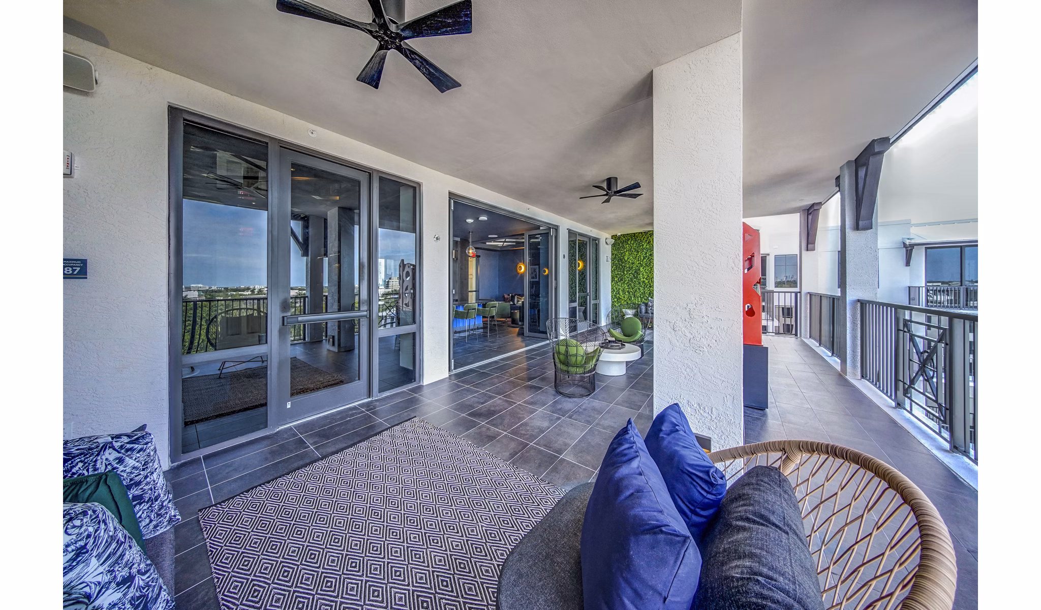 Outdoor seating patio area at The Ellsworth Apartments featuring stylish furniture and landscaped views