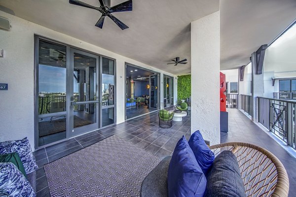 Outdoor seating patio area at The Ellsworth Apartments featuring stylish furniture and landscaped views