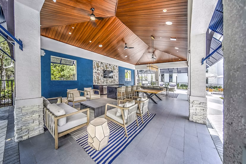 Grill area with seating on patio at The Ellsworth Apartments