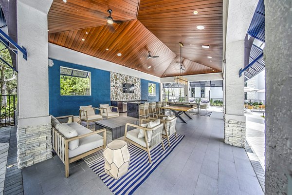 Grill area with seating on patio at The Ellsworth Apartments