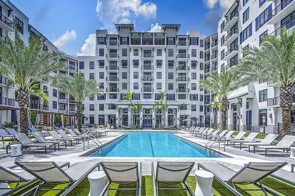 Resort-style pool with lounge seating at The Ellsworth Apartments