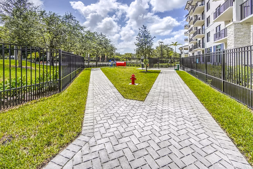 Dog-friendly park with play equipment at The Ellsworth Apartments, ideal for pet owners seeking luxury living