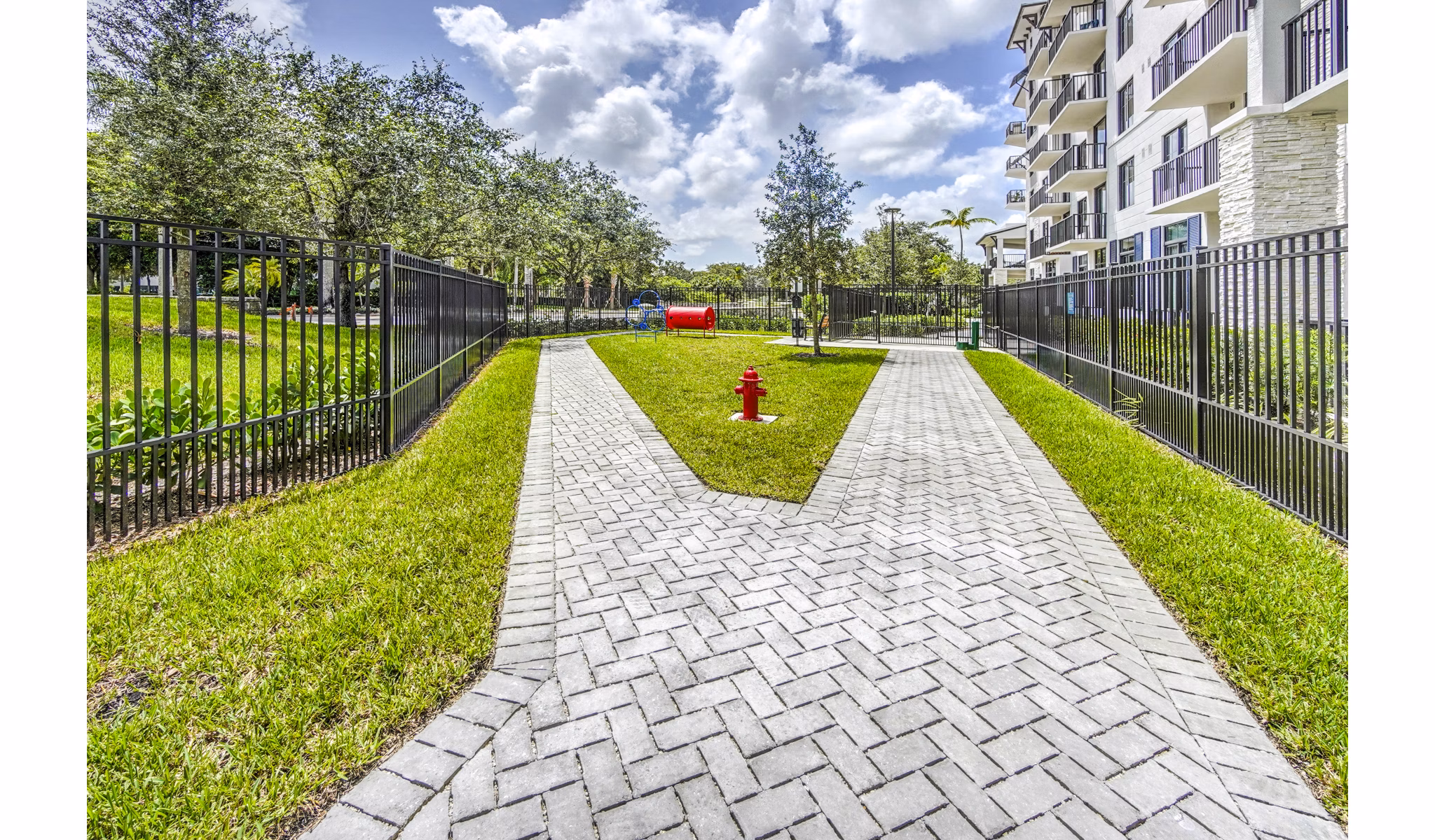 Dog-friendly park with play equipment at The Ellsworth Apartments, ideal for pet owners seeking luxury living
