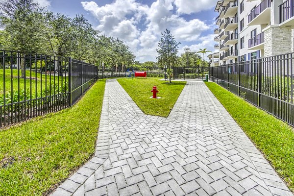 Dog-friendly park with play equipment at The Ellsworth Apartments, ideal for pet owners seeking luxury living